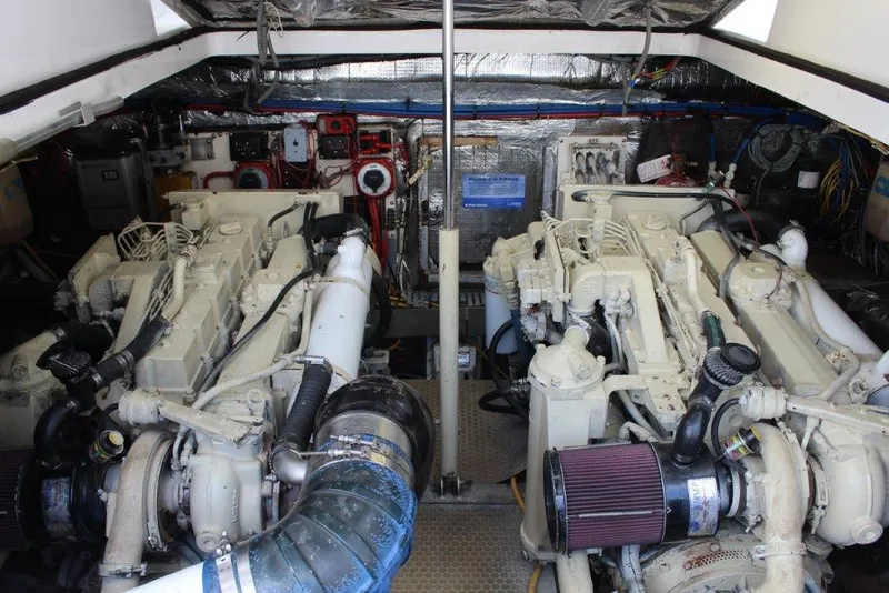 Slide: The Image of Engine room of 2002 Luhrs Express boat with dual engines and mechanical components. - 16