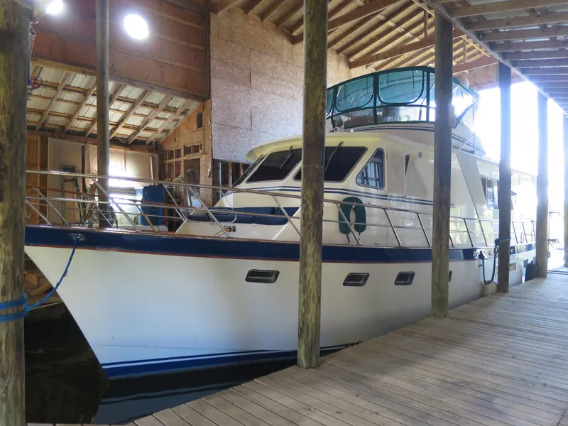 The Image of 1988 DeFever 53POC yacht docked in a wooden boathouse. - 0