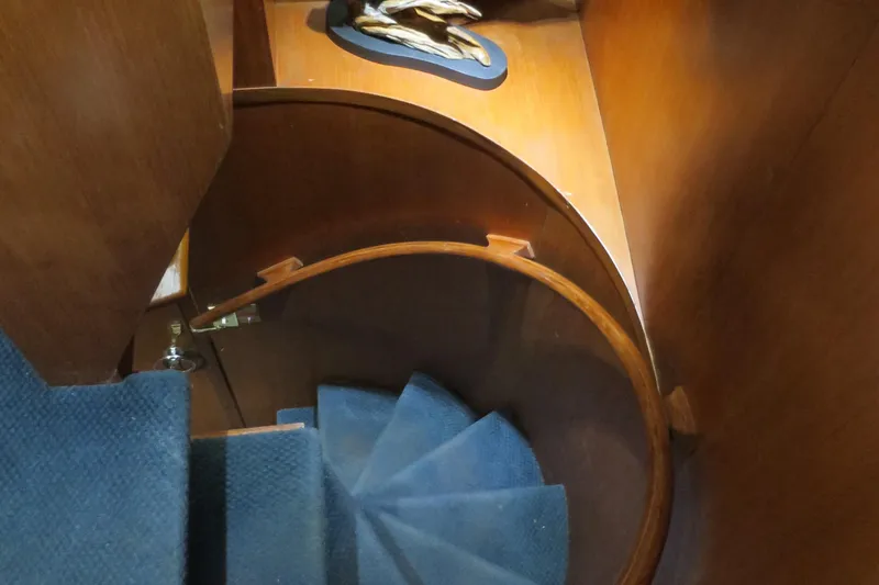 Slide: The Image of Spiral staircase on 1988 DeFever 53POC yacht with wooden and carpeted design. - 13