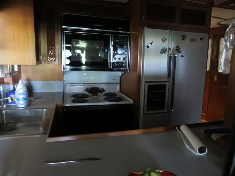 Slide: The Image of 1988 DeFever 53POC yacht kitchen with stove, oven, and refrigerator. - 14