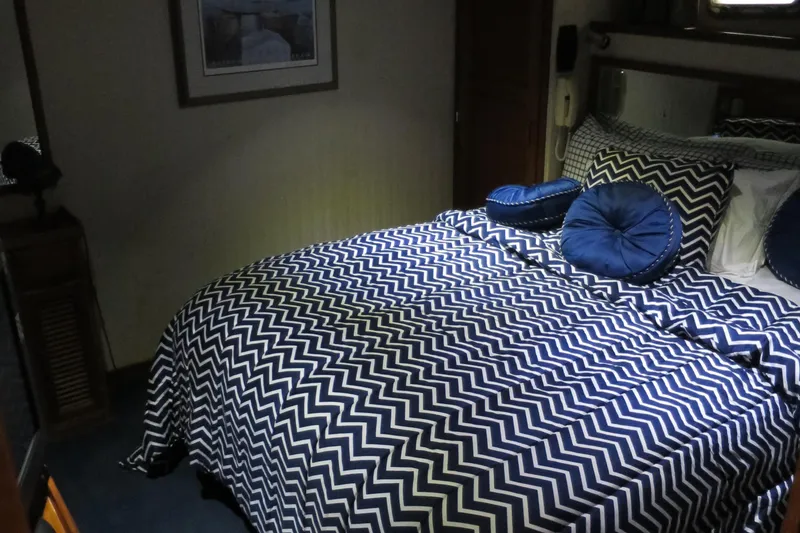 Slide: The Image of Bedroom interior of 1988 DeFever 53POC yacht with chevron-patterned bedding. - 15
