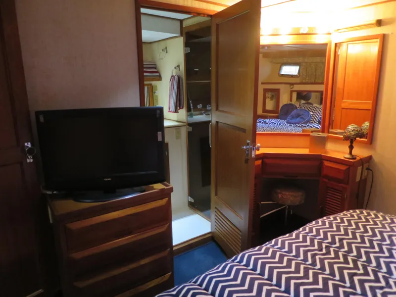 Slide: The Image of Interior of 1988 DeFever 53POC yacht with bedroom, TV, and vanity area. - 16