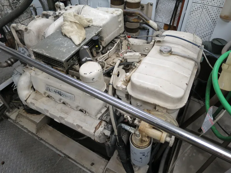 Slide: The Image of Engine room of 1988 DeFever 53POC yacht, featuring a well-maintained marine engine. - 19