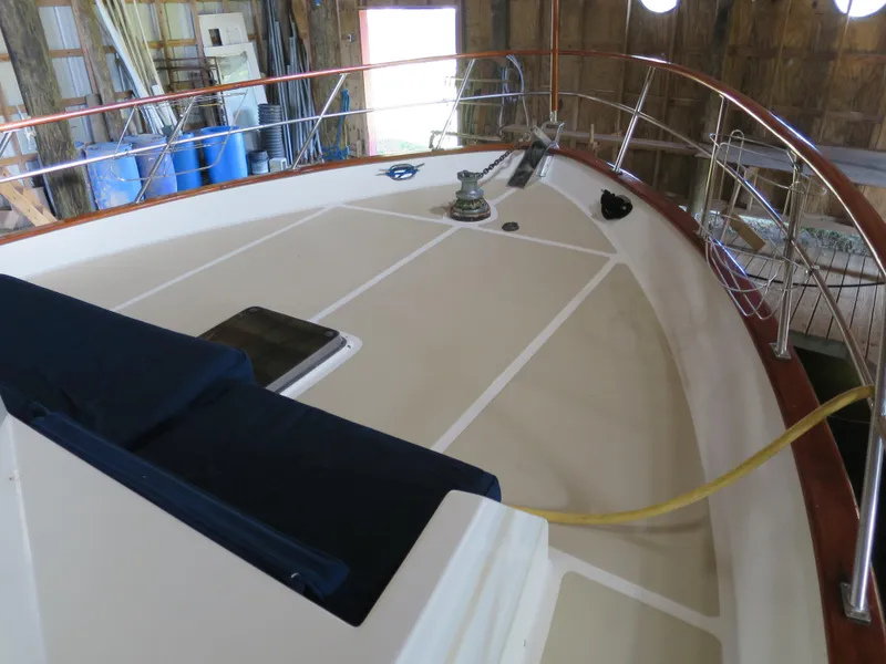 Slide: The Image of 1988 DeFever 53POC yacht deck with railing and winch in a storage facility. - 2