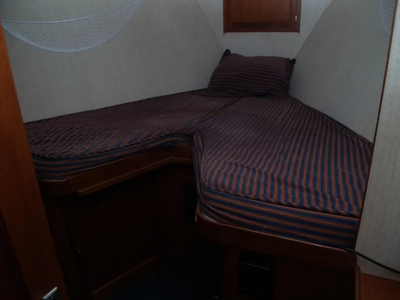 Slide: The Image of 1988 DeFever 53POC cabin with striped bedding and wooden interior. - 23