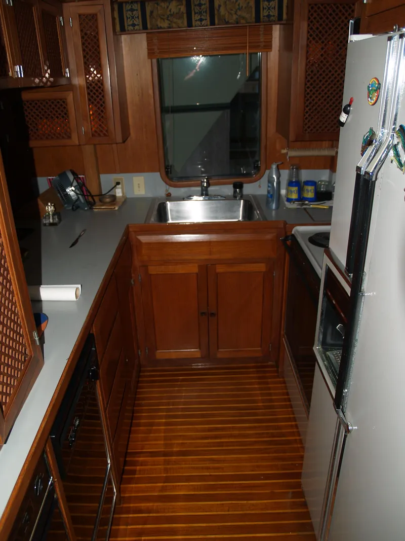 Slide: The Image of 1988 DeFever 53POC yacht kitchen with wooden cabinetry and flooring. - 27