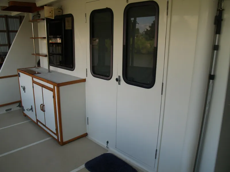 Slide: The Image of 1988 DeFever 53POC yacht interior with cabinets and doors, featuring a clean, organized design. - 28