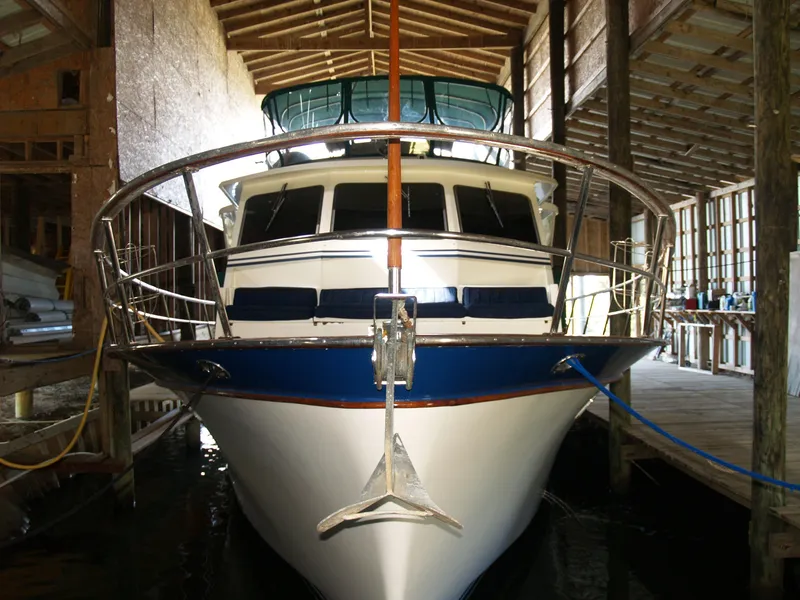 Slide: The Image of 1988 DeFever 53POC yacht docked in a covered marina. - 29
