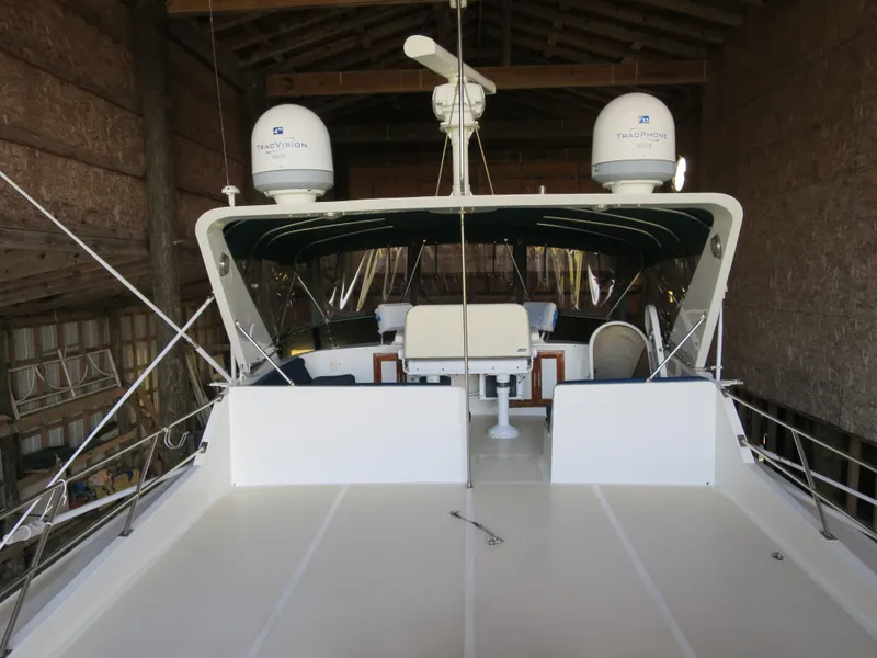 Slide: The Image of 1988 DeFever 53POC yacht in storage, featuring spacious deck and navigation equipment. - 3