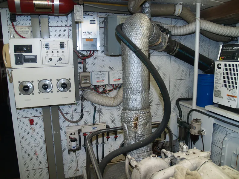 Slide: The Image of Engine room of 1988 DeFever 53POC yacht with control panels and insulated pipes. - 30