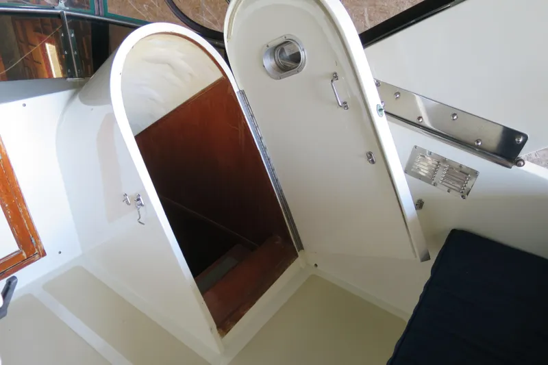 Slide: The Image of 1988 DeFever 53POC yacht interior with open hatch and wooden stairs. - 5