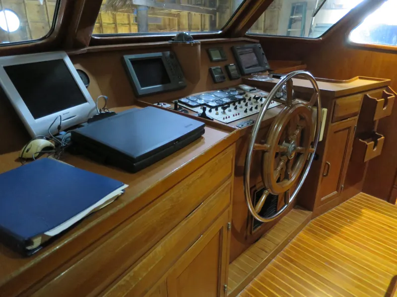 Slide: The Image of 1988 DeFever 53POC yacht helm with wooden steering wheel and navigation equipment. - 7