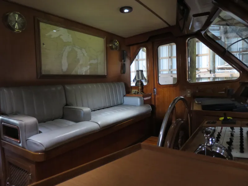 Slide: The Image of 1988 DeFever 53POC yacht interior with leather seating and nautical decor. - 9