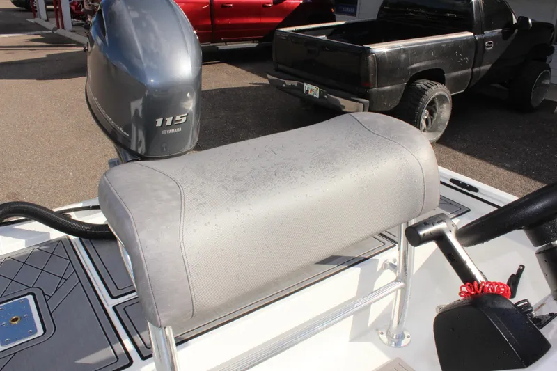 Slide: The Image of Avid 18 Rogue CC 2025 boat seat and motor, parked near trucks. - 10