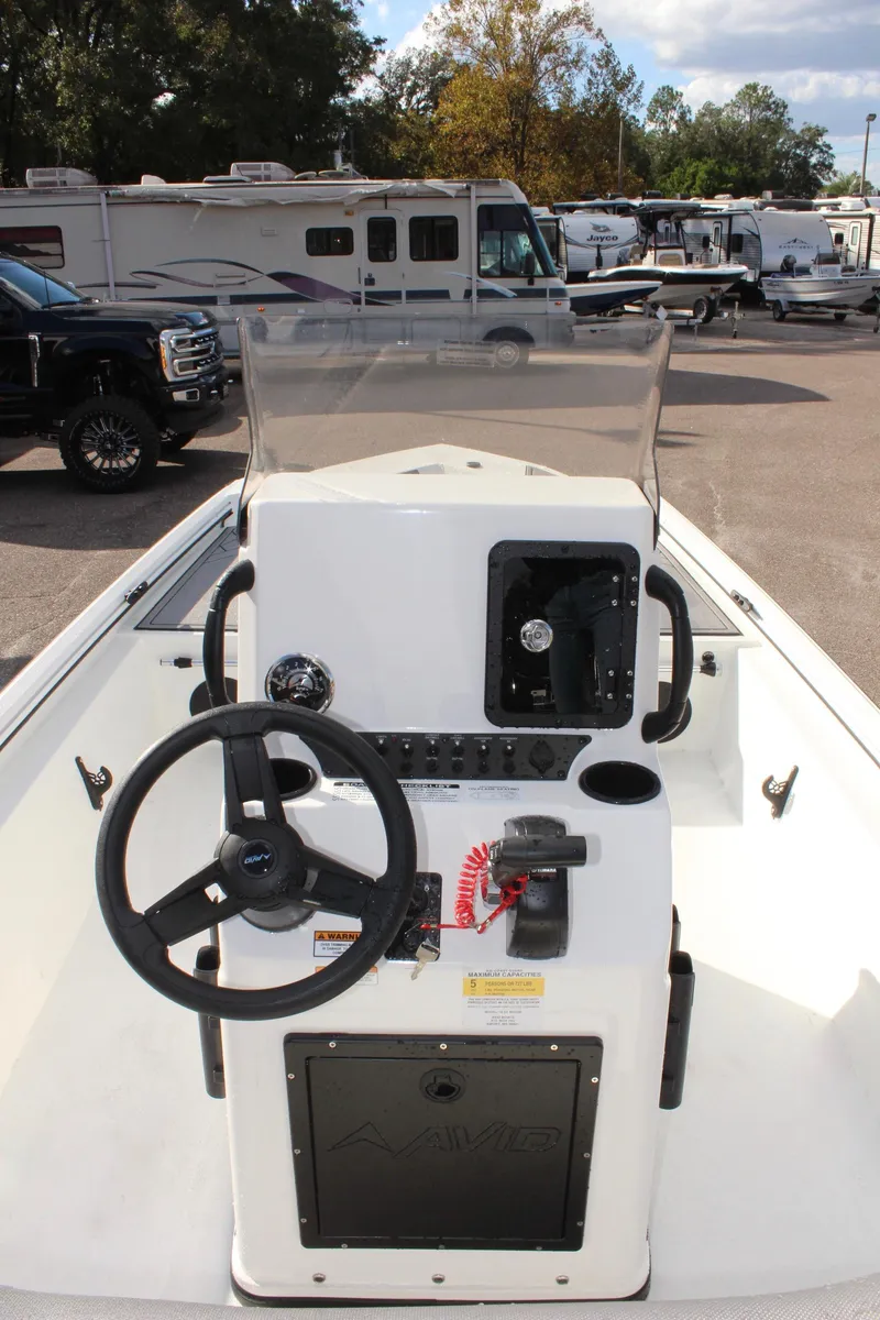 Slide: The Image of 2025 Avid 18 Rogue CC boat console with steering wheel and controls. - 11