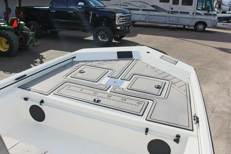 Slide: The Image of 2025 Avid 18 Rogue CC boat deck with storage compartments and ruler markings. - 13
