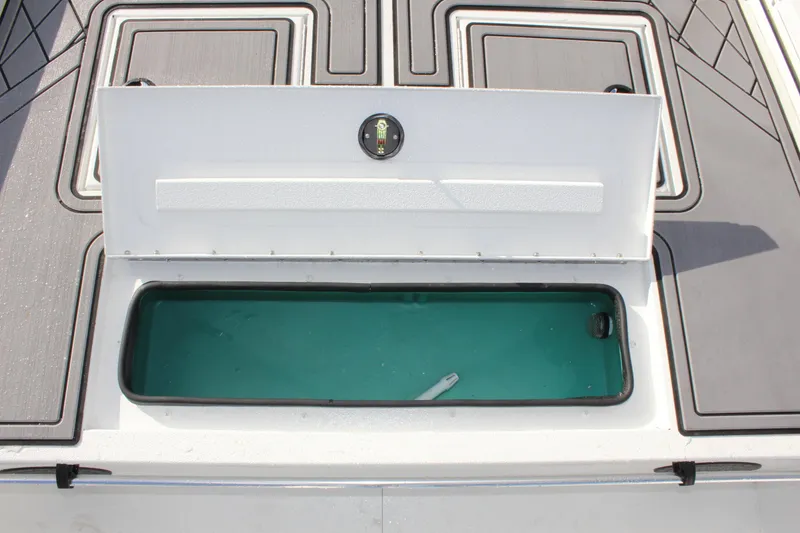 Slide: The Image of Avid 18 Rogue CC 2025 boat storage compartment with open lid. - 16