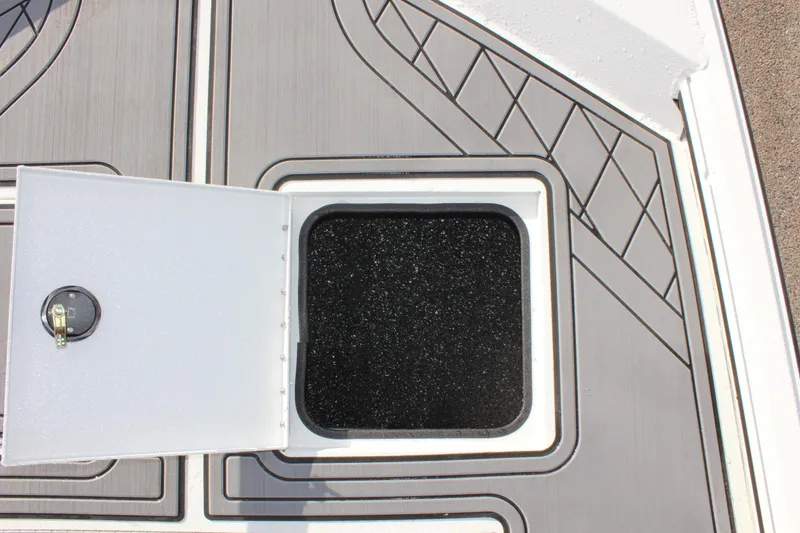Slide: The Image of Open storage compartment on 2025 Avid 18 Rogue CC boat deck. - 18