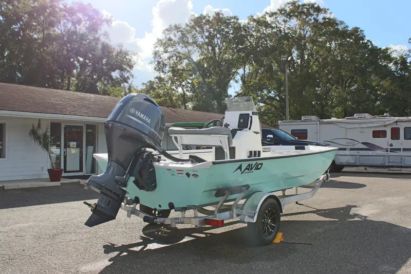 Slide: The Image of 2025 Avid 18 Rogue CC boat with Yamaha engine on trailer, parked outdoors. - 7
