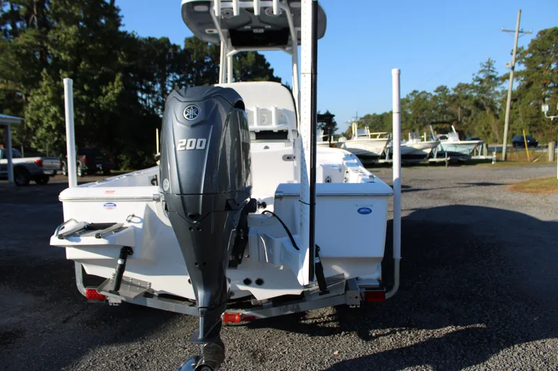 Slide: The Image of 2025 Tidewater 2210 Carolina Bay boat with Yamaha 200 engine, parked outdoors. - 13