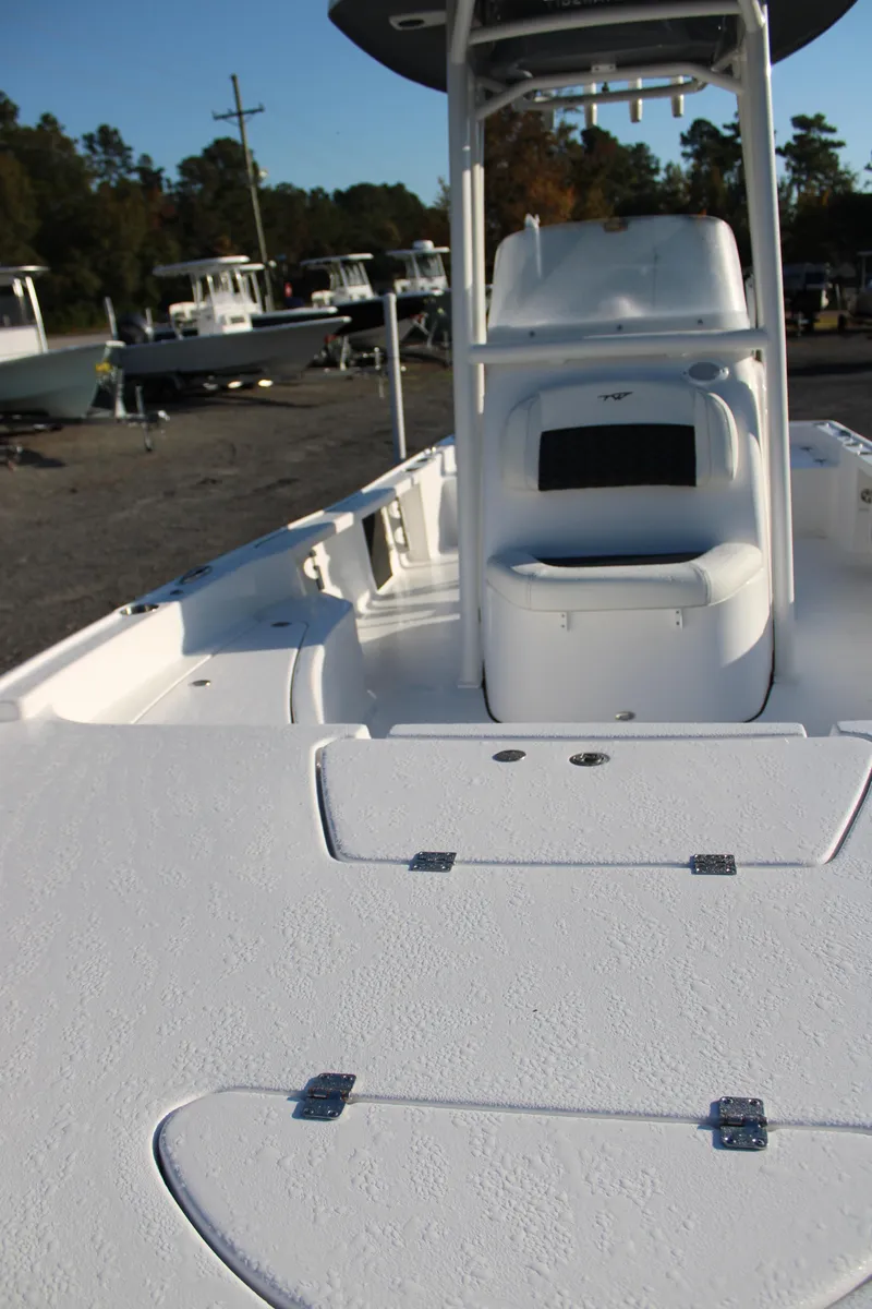 Slide: The Image of 2025 Tidewater 2210 Carolina Bay boat interior with seating and storage compartments. - 16