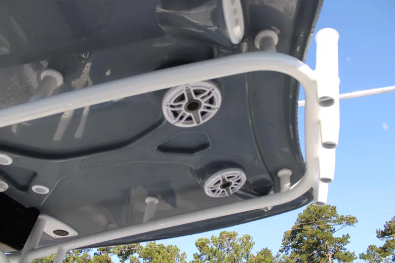 Slide: The Image of 2025 Tidewater 2210 Carolina Bay boat with speakers and rod holders on the T-top. - 20