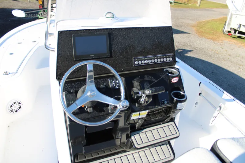 Slide: The Image of 2025 Tidewater 2210 Carolina Bay boat console with steering wheel and controls. - 6
