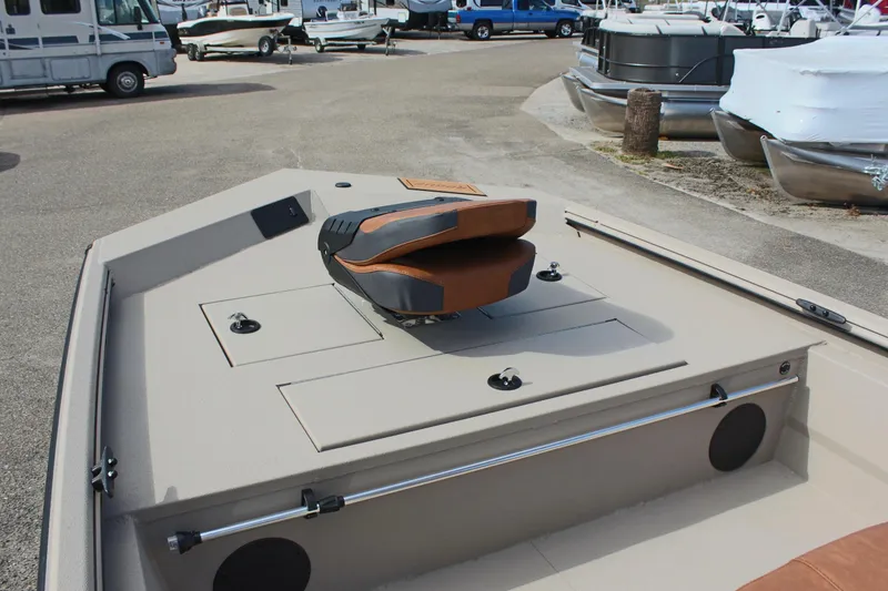 Slide: The Image of 2025 Avid 18 Rogue CC boat deck with seating, parked in a marina. - 14