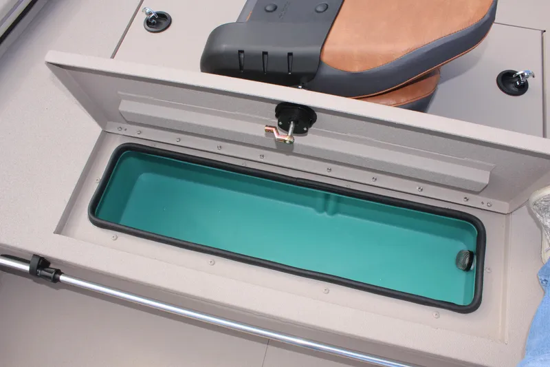 Slide: The Image of Avid 18 Rogue CC 2025 boat storage compartment with open lid and seat. - 16