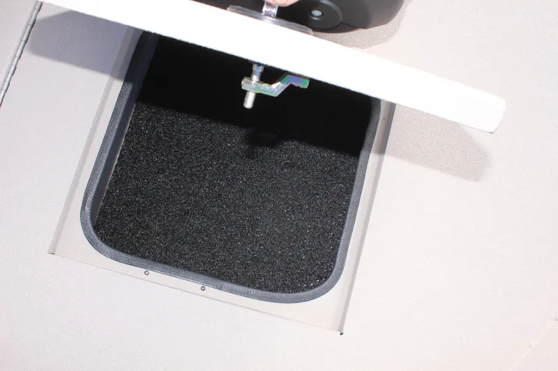 Slide: The Image of Avid 18 Rogue CC 2025 boat storage compartment with open hatch. - 18