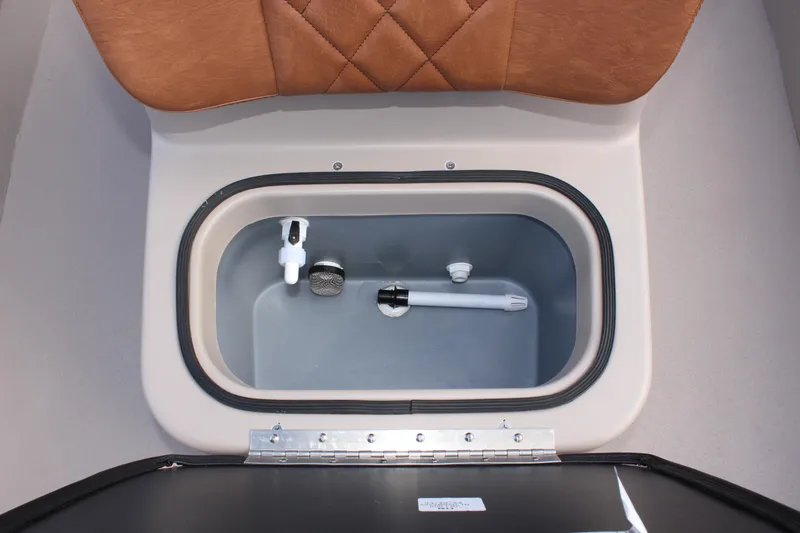 Slide: The Image of Avid 18 Rogue CC 2025 boat storage compartment with cushioned seat. - 21