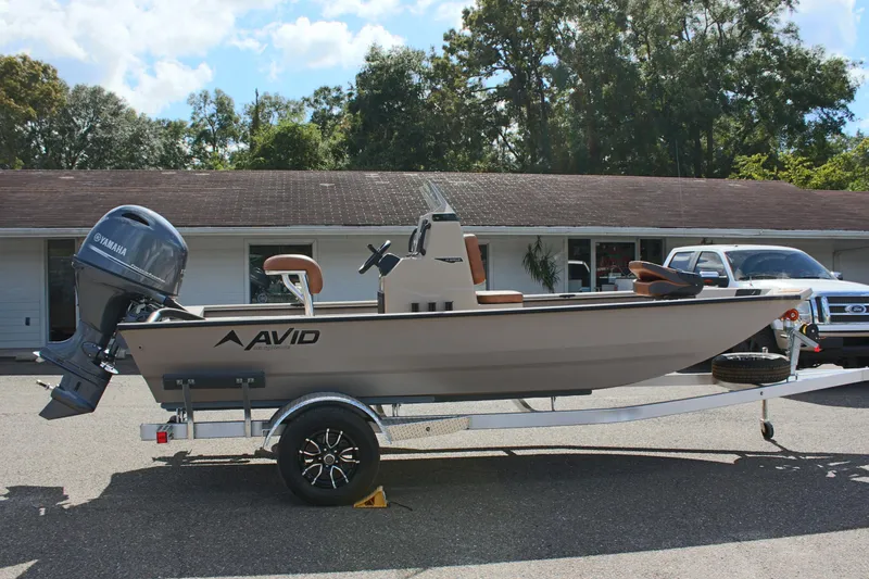 Slide: The Image of 2025 Avid 18 Rogue CC boat on trailer, parked outdoors. - 6