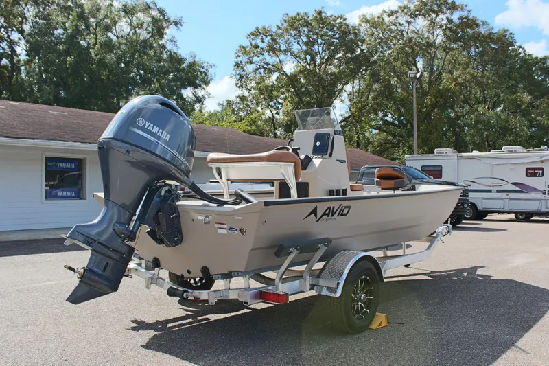Slide: The Image of 2025 Avid 18 Rogue CC boat with Yamaha motor on trailer, parked outdoors. - 7