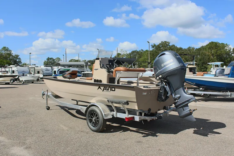 Slide: The Image of 2025 Avid 18 Rogue CC boat on trailer, parked outdoors under blue sky. - 9