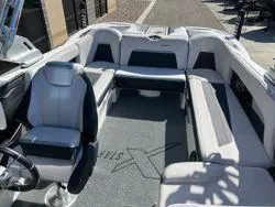 Slide: The Image of 2021 MasterCraft XStar boat interior with plush seating and modern design. - 10
