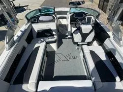Slide: The Image of 2021 MasterCraft XStar boat interior with sleek seating and modern dashboard design. - 12
