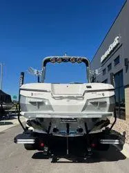 Slide: The Image of 2021 MasterCraft XStar boat parked outside a dealership under clear blue skies. - 2