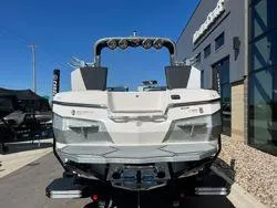 Slide: The Image of 2021 MasterCraft XStar boat, rear view, parked outside dealership. - 5