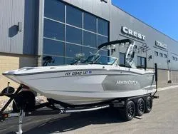 Slide: The Image of 2021 MasterCraft XStar boat on trailer outside dealership. - 7