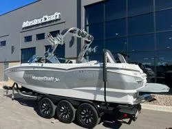 Slide: The Image of 2021 MasterCraft XStar boat on trailer outside dealership. - 8