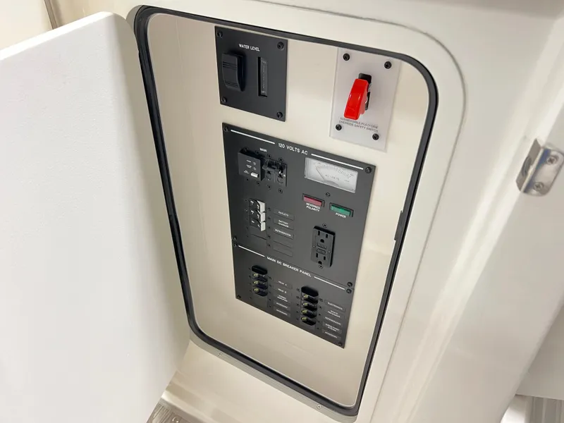 Slide: The Image of Electrical panel inside 2025 Sea Ray SLX 310 boat, featuring switches and circuit breakers. - 12