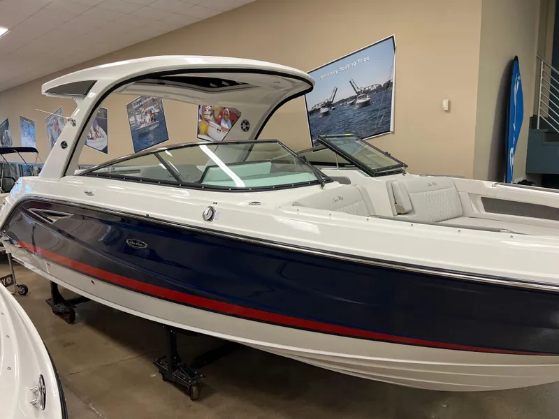 Slide: The Image of 2025 Sea Ray SLX 310 boat displayed indoors, featuring sleek design and modern amenities. - 2