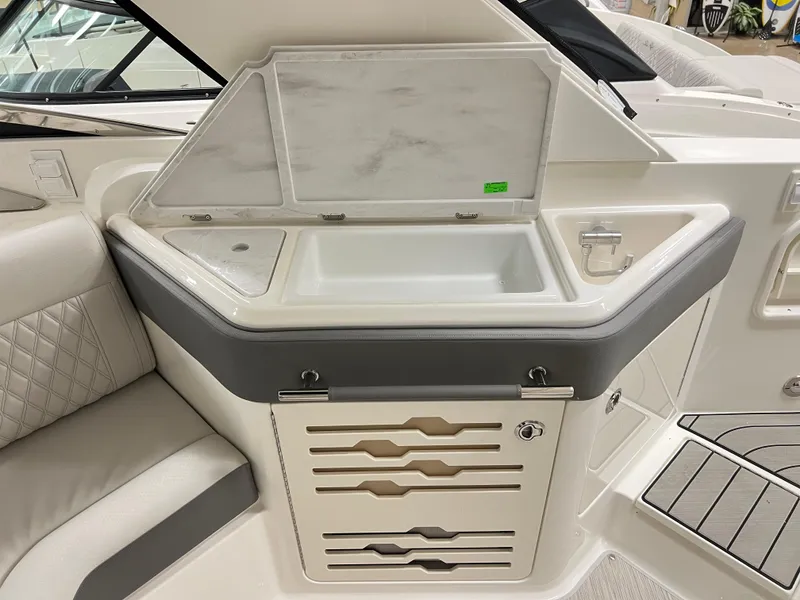 Slide: The Image of 2025 Sea Ray SLX 310 boat interior with sink and storage area. - 7