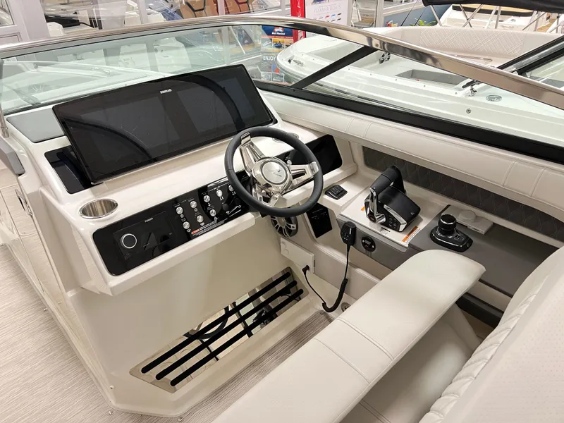 Slide: The Image of 2025 Sea Ray SLX 310 helm with modern controls and sleek design. - 8