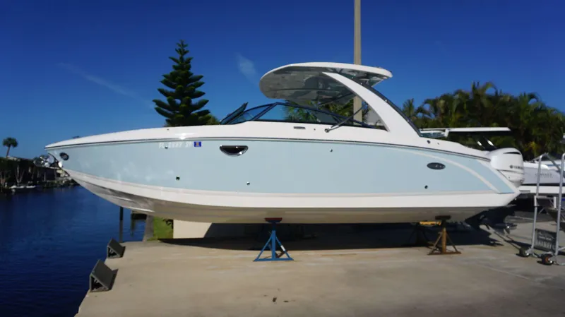 Slide: The Image of 2020 Cobalt 30 SC boat on display by the water. - 1