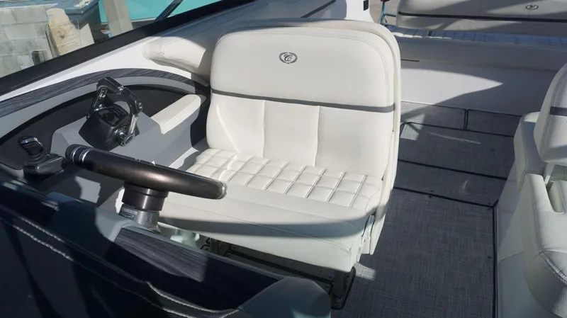 Slide: The Image of 2020 Cobalt 30 SC boat interior with white leather seating and steering wheel. - 10