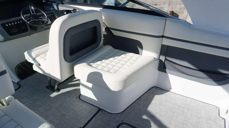 Slide: The Image of 2020 Cobalt 30 SC boat interior with white seating and modern dashboard. - 14