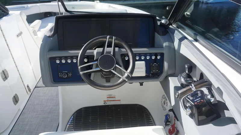 Slide: The Image of 2020 Cobalt 30 SC boat helm with steering wheel and control panel. - 16