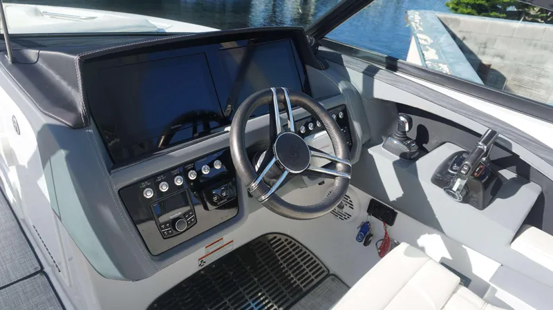 Slide: The Image of 2020 Cobalt 30 SC boat dashboard with steering wheel and control panel. - 17