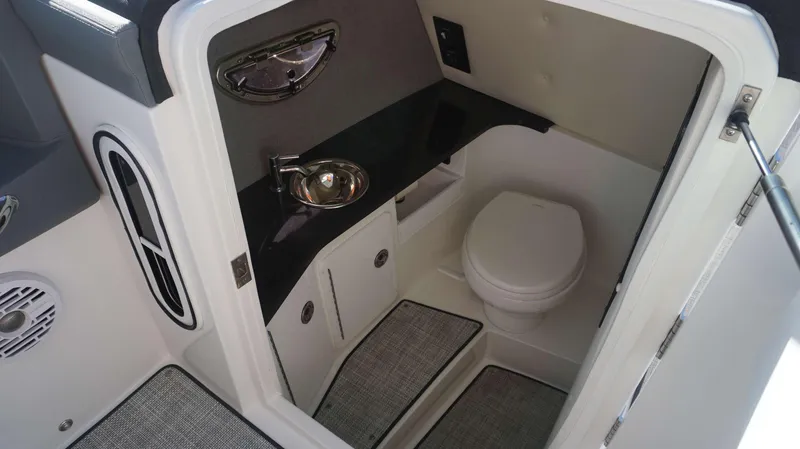 Slide: The Image of 2020 Cobalt 30 SC boat interior bathroom with sink and toilet. - 19